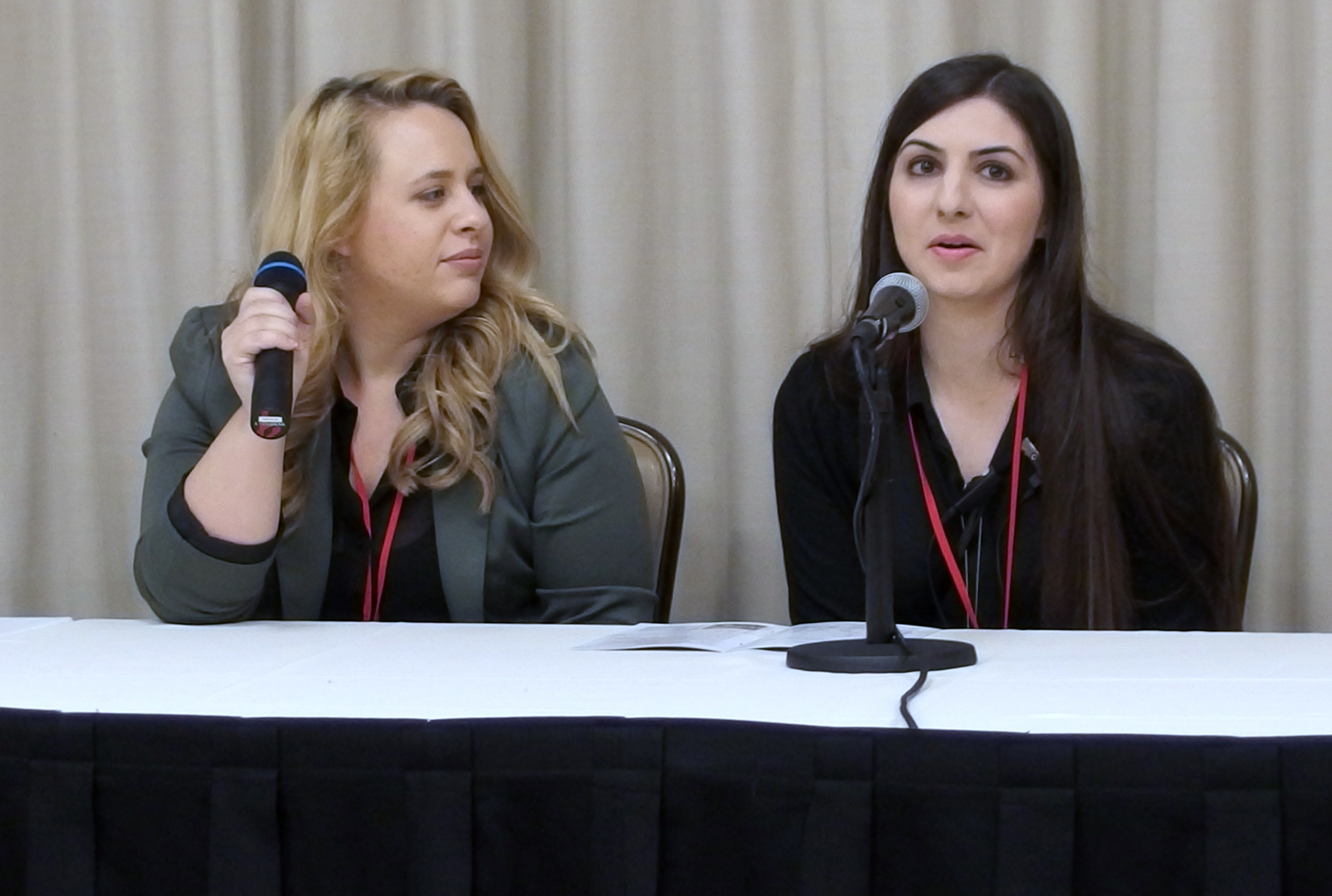 Moderator Liz Schleder introduces Roxy Nazari to the press