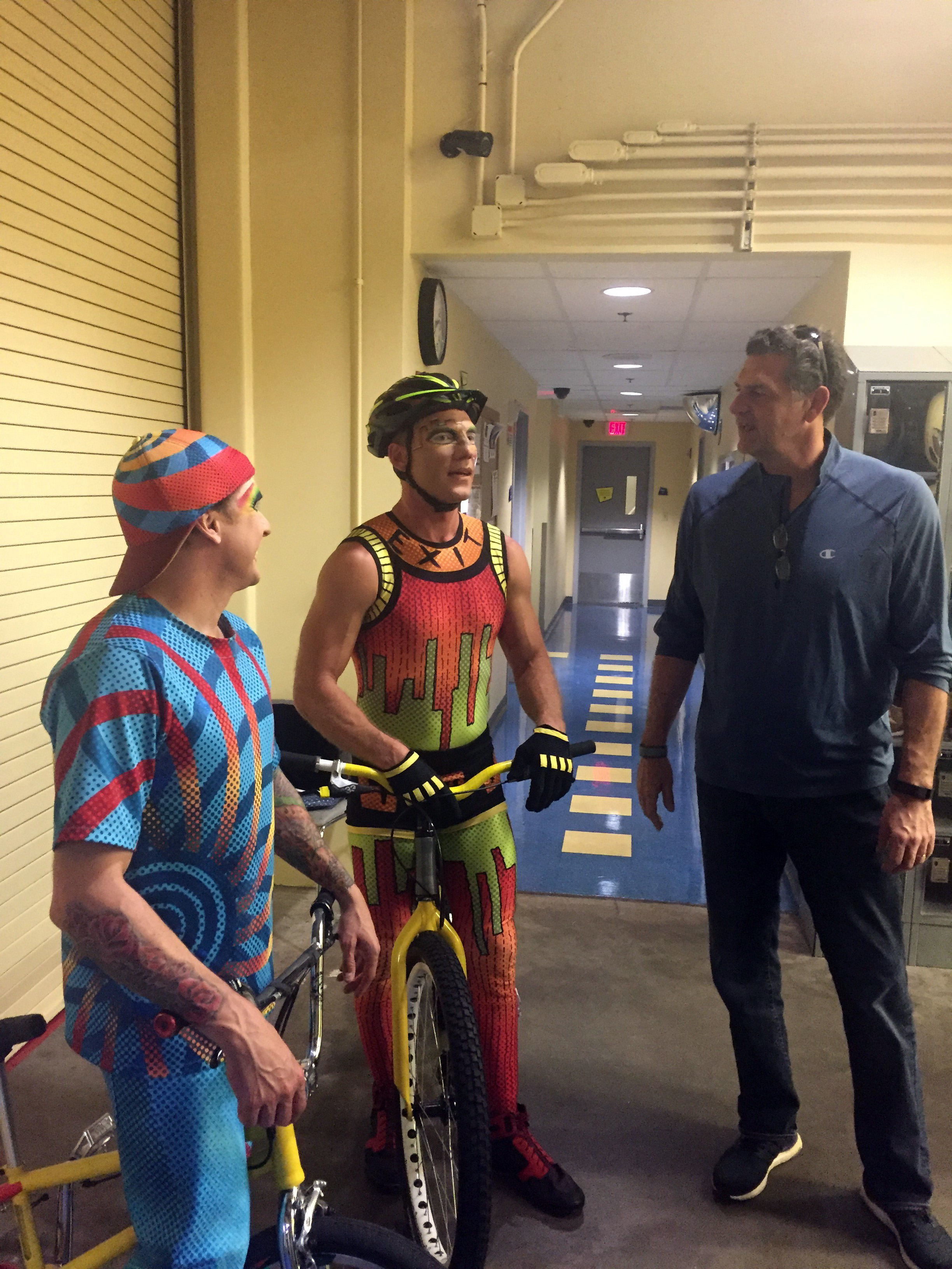 Mike Golic of ESPN’s Mike and Mike chats with the bicycle performers of La Nouba by Cirque du Soleil at Disney Springs while in Orlando for the NFL Pro Bowl.