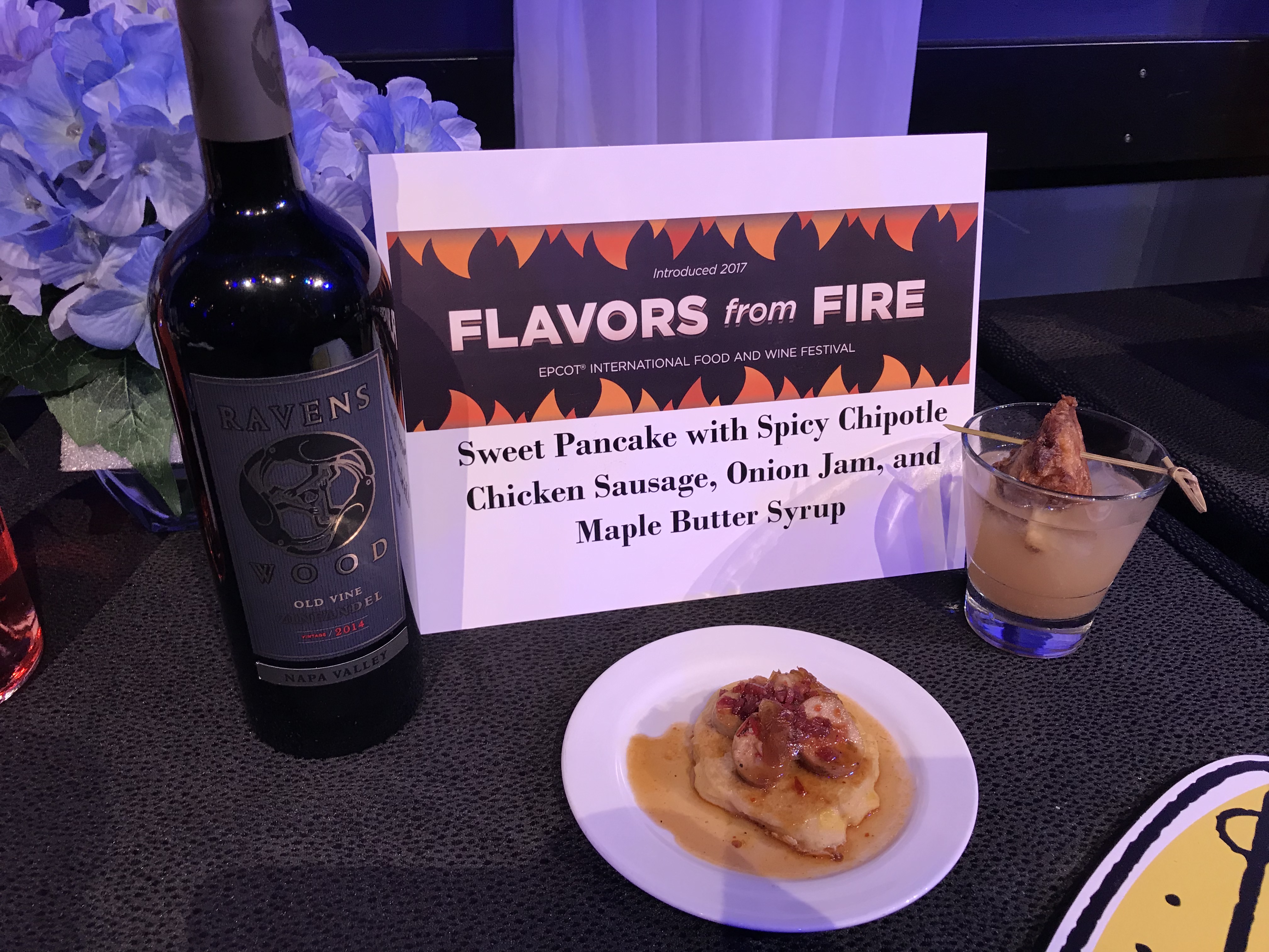 Epcot International Food & Wine Festival - Flavors from Fire Marketplace Sweet Pancake with Spicy Chipotle Chicken Sausage, Onion Jam, and Maple Butter Syrup and Swine Brine featuring Evan Williams Bourbon