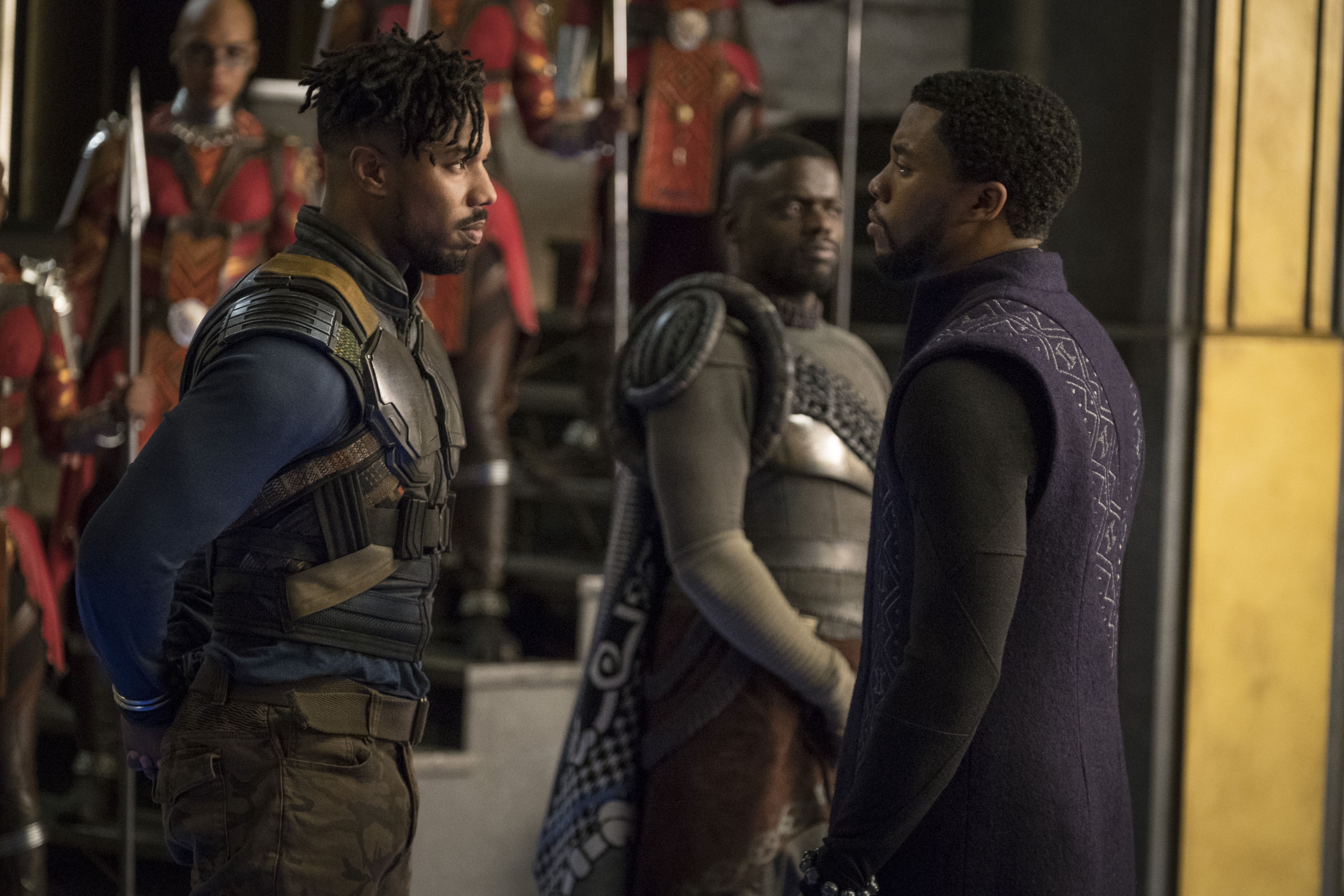 Marvel Studios' BLACK PANTHER..L to R: Erik Killmonger (Michael B. Jordan) and T'Challa/Black Panther (Chadwick Boseman), b/g W'Kabi (Daniel Kaluuya)..Photo: Matt Kennedy..©Marvel Studios 2018