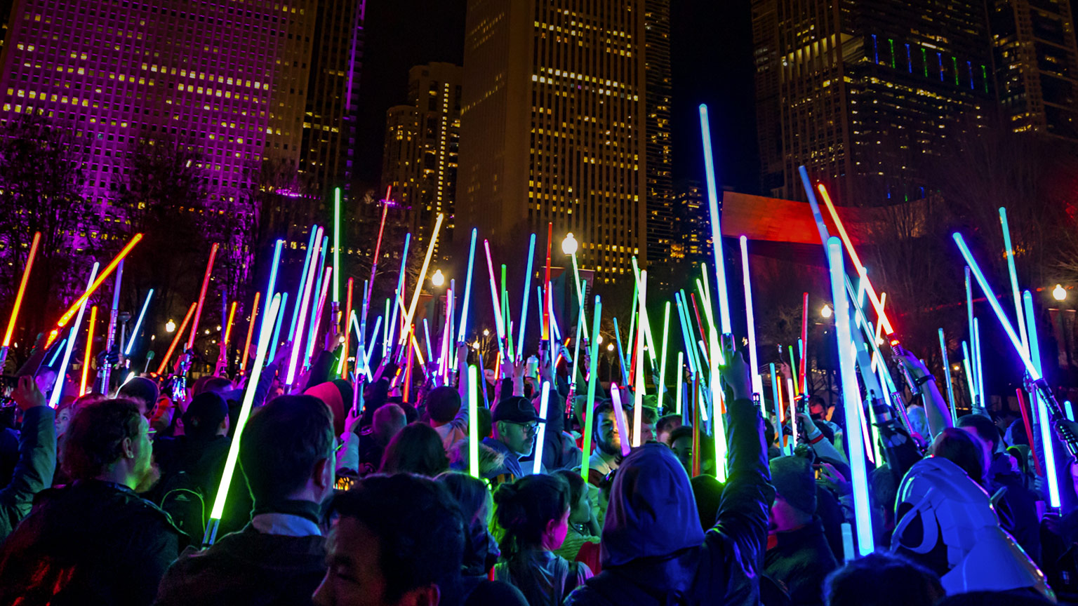 Star Wars fans hold lightsabers at night in Chicago.