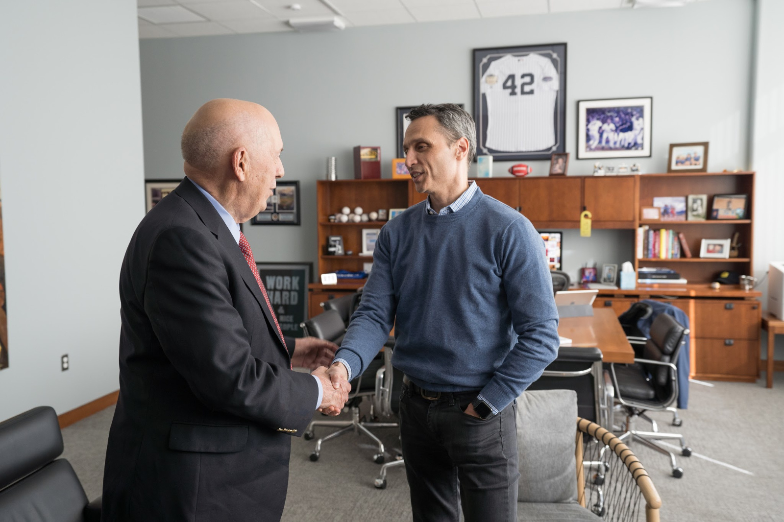 ESPN founder Bill Rasmussen (L) visits with ESPN President Jimmy Pitaro. (Joe Faraoni/ESPN Images)