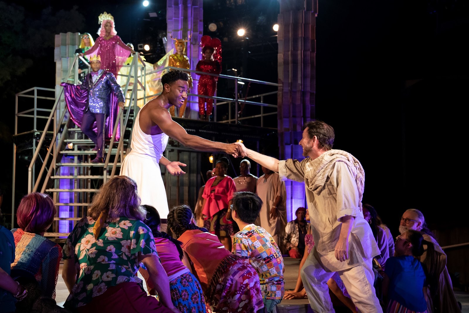 Jelani Alladin (center) and the company of The Public Theater’s free Public Works musical adaptation of Hercules, with music by Alan Menken, lyrics by David Zippel, book by Kristoffer Diaz, choreography by Chase Brock, and directed by Lear deBessonet, running at the Delacorte Theater. Photo credit: Joan Marcus.