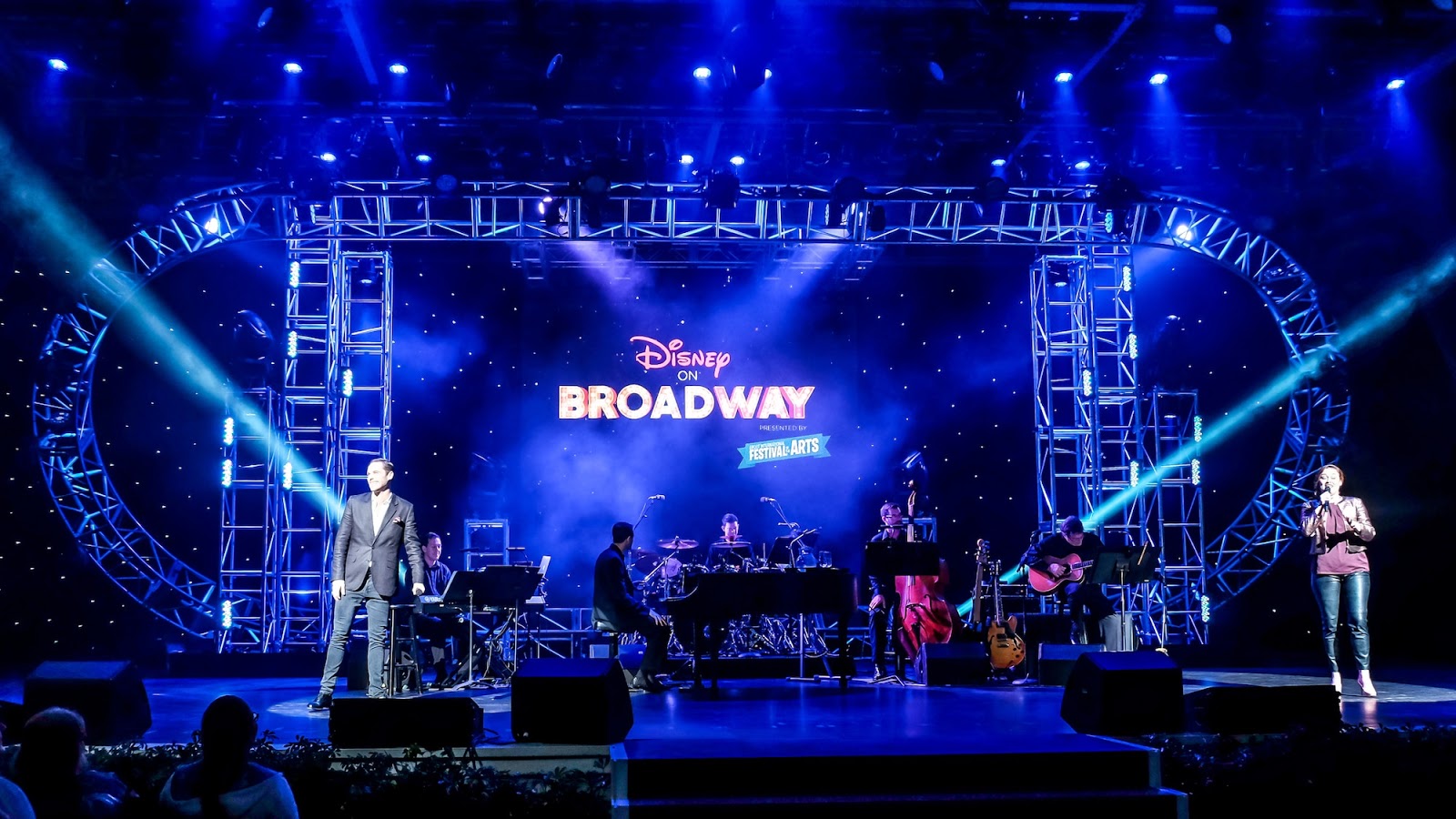 The Disney on Broadway sign lights up a stage filled with instruments at the Festival of the Arts
