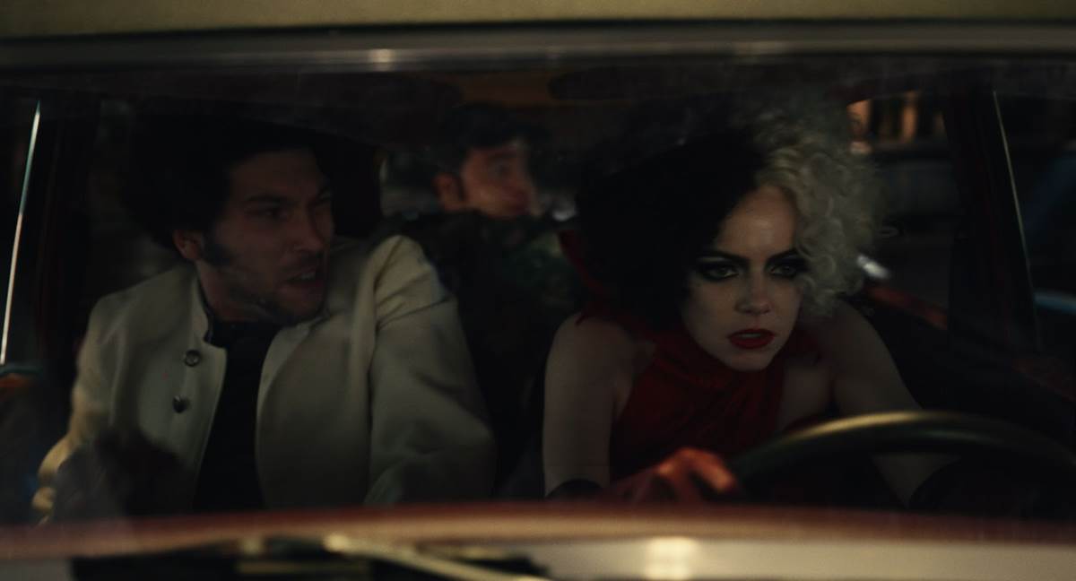 (L-R): Joel Fry as Jasper, Paul Walter Hauser as Horace and Emma Stone as Cruella in Disney's live-action CRUELLA. Photo courtesy of Disney. © 2021 Disney Enterprises Inc. All Rights Reserved.