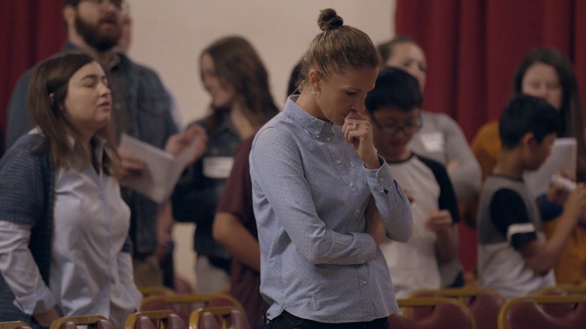 Conversion therapy survivor Julie Rodgers at church in Pray Away. Directed by Kristine Stolakis. Image courtesy of Multitude Films.