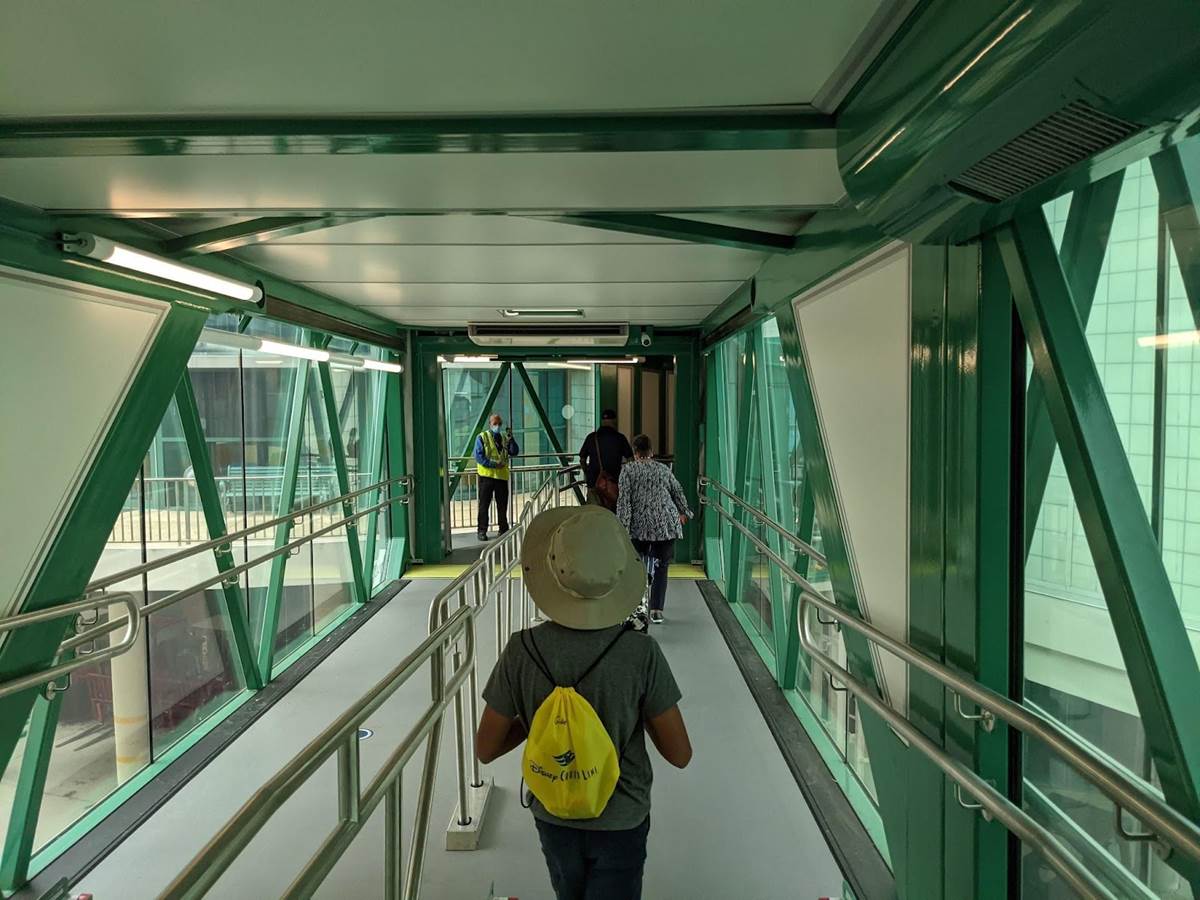 Gideon proudly wearing his yellow Disney Cruise Line backpack during debarkation