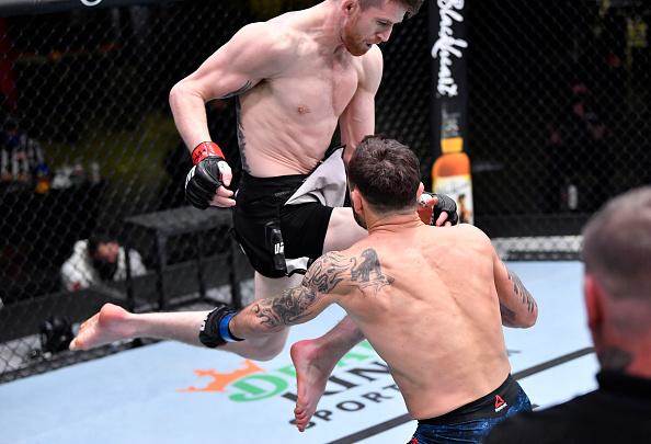 Cory Sandhagen lands a flying knee against Frankie Edgar