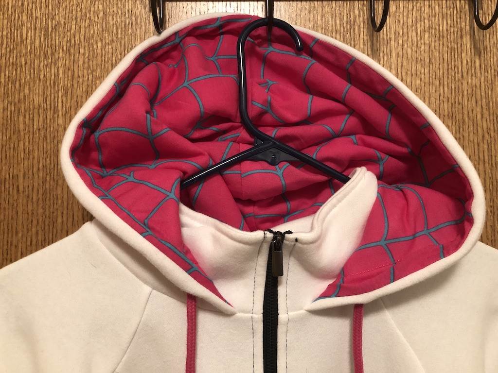 Pink and teal lined hoodie. Collar extends to the chin and the hood attaches at the neckline. I LOVE IT!