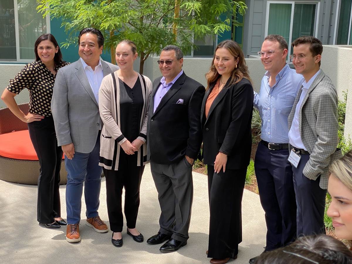 Disney's representatives at the Finamore Place event pose for a photo after the Grand Opening ceremony