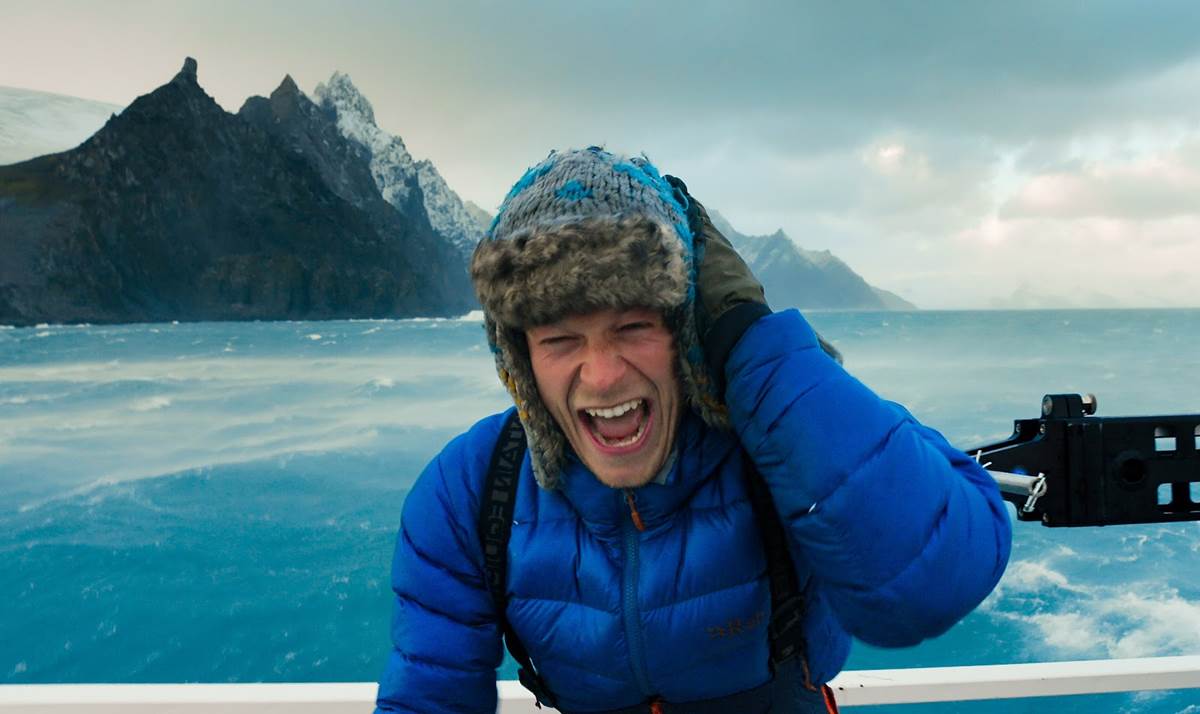 Bertie Gregory on boat in harsh Antarctic weather. (Credit: National Geographic/Will West for Disney+)
