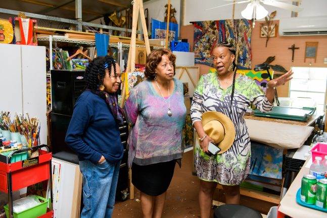 Carmen Smith, senior vice president, Creative Development - Product/Content & Inclusive Strategies,  fellow Imagineer Charita Carter and local artist Malaika Favorite discuss Tiana's Bayou Adventure